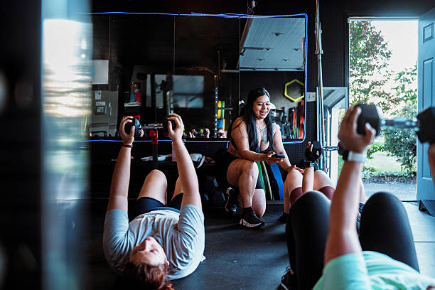 female fitness instructor encouraging fitness class participants during workout